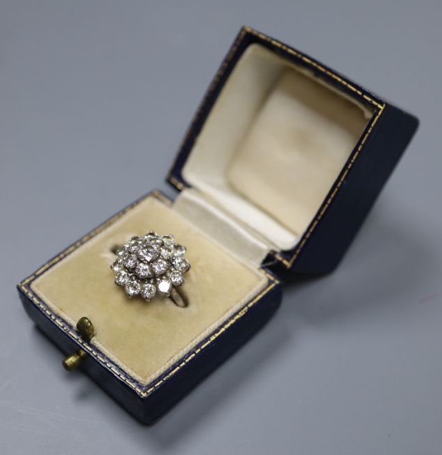 A white metal (stamped 18ct) and domed diamond cluster ring, size J, gross 4.7 grams.